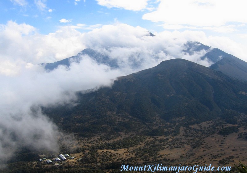 The cloud filled crater of Mt. Meru, with the Saddle Huts in the bottom left corner.